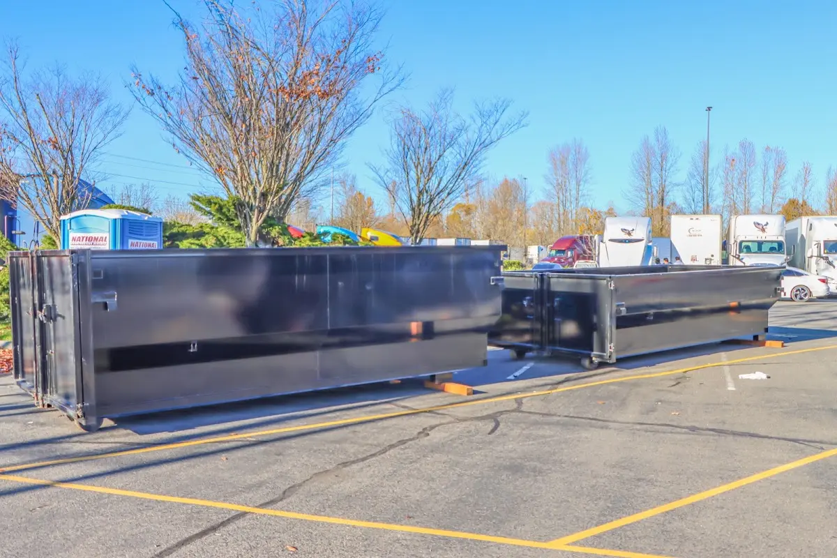 Professional dumpster rental service with roll-off container on residential driveway in Bostonia